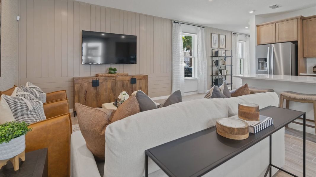 Open family room and kitchen in a DRB Home Clementine model at the Trinity Place community.