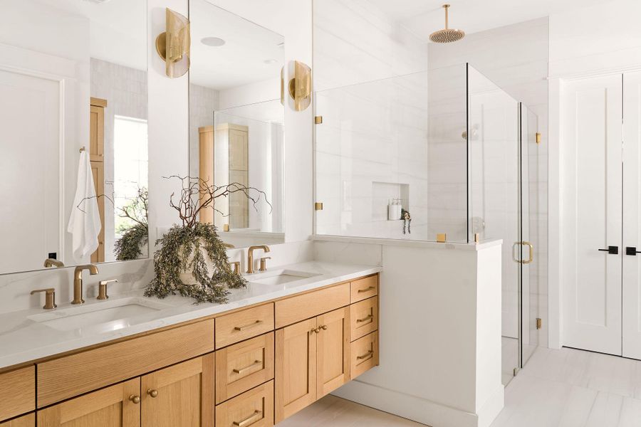 Full bathroom featuring a shower stall and double vanity Full bathroom featuring a shower stall and double vanity