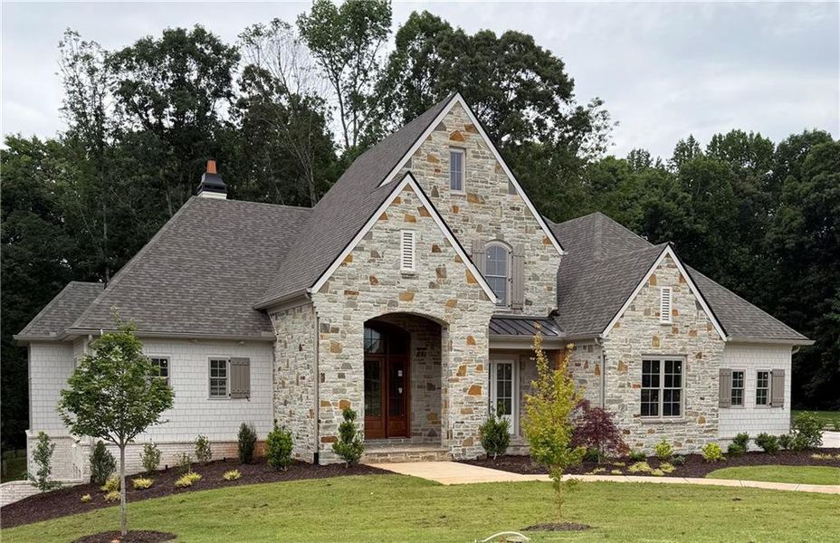 Front exterior of a new home in , Flowery Branch, GA, highlighting curb appeal (Image 10).