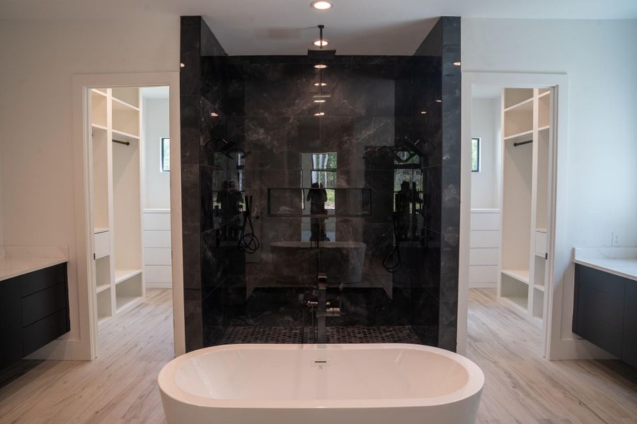 Well-designed primary bathroom with oversized shower, soaking tub, and double sinks.