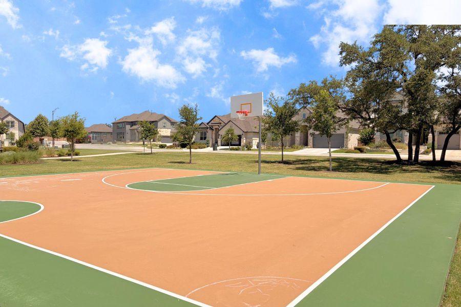 A vibrant basketball court offers a recreational haven amidst a pleasant neighborhood setting. A vibrant basketball court offers a recreational haven amidst a pleasant neighborhood setting.