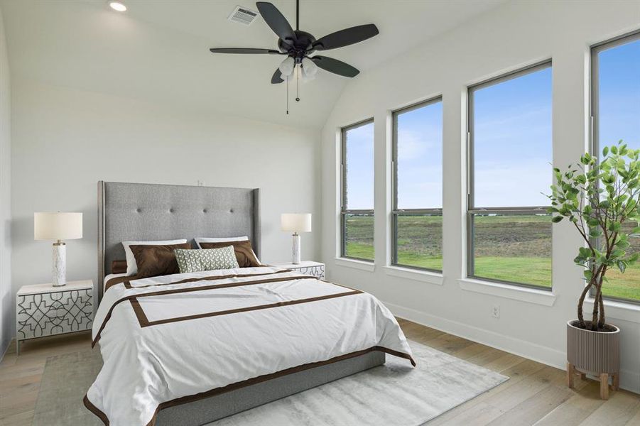 Bedroom with vaulted ceiling, ceiling fan, and light hardwood / wood-style floors *VIRTUAL STAGING