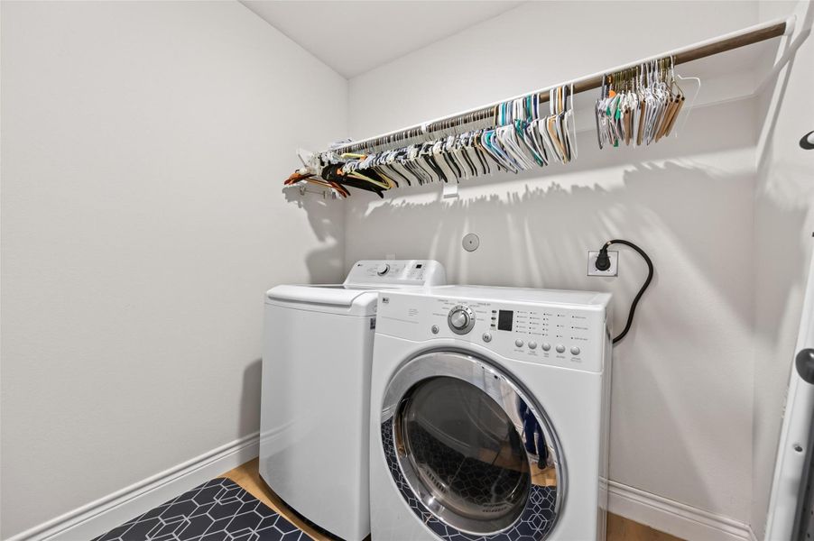 This utility room is designed for maximum efficiency and organization, featuring convenient built-in clothes hangers that provide the perfect solution for drying garments or staging laundry. Tucked neatly behind the door, you will find a spacious, custom-built storage shelf that utilizes vertical space to keep your cleaning supplies, detergents, and household essentials perfectly tucked away yet easily accessib This utility room is designed for maximum efficiency and organization, featuring convenient built-in clothes hangers that provide the perfect solution for drying garments or staging laundry. Tucked neatly behind the door, you will find a spacious, custom-built storage shelf that utilizes vertical space to keep your cleaning supplies, detergents, and household essentials perfectly tucked away yet easily accessib