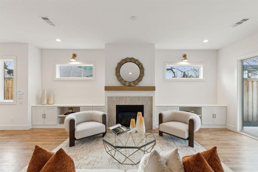 Living room featuring light hardwood / wood-style flooring and a fireplace