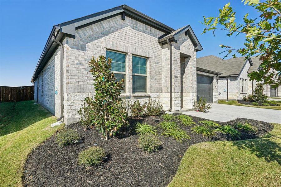 Front exterior of a new home in Lakehaven - Signature Series, Farmersville, TX, highlighting curb appeal (Image 2). Front exterior of a new home in Lakehaven - Signature Series, Farmersville, TX, highlighting curb appeal (Image 2).