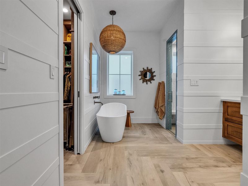 Indulge in spa-inspired serenity! The primary bathroom features a freestanding soaking tub, elegant double vanities, and a spacious master closet—designed for ultimate functionality and style. Soft textures and thoughtful lighting create an atmosphere of refined relaxation. This space exemplifies coastal luxury at its best, where every detail—from layout to finish—has been carefully curated for everyday comfort and timeless elegance. Indulge in spa-inspired serenity! The primary bathroom features a freestanding soaking tub, elegant double vanities, and a spacious master closet—designed for ultimate functionality and style. Soft textures and thoughtful lighting create an atmosphere of refined relaxation. This space exemplifies coastal luxury at its best, where every detail—from layout to finish—has been carefully curated for everyday comfort and timeless elegance.