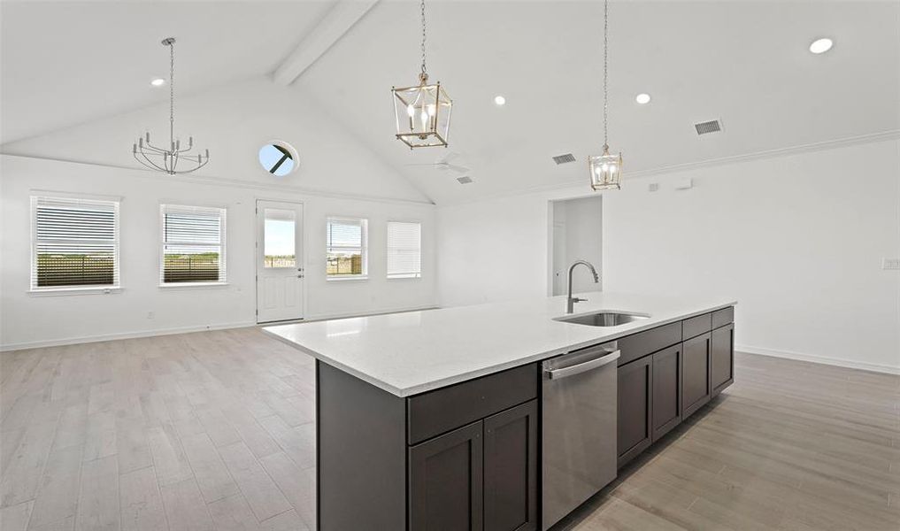 Kitchen overlooks great room and dining area