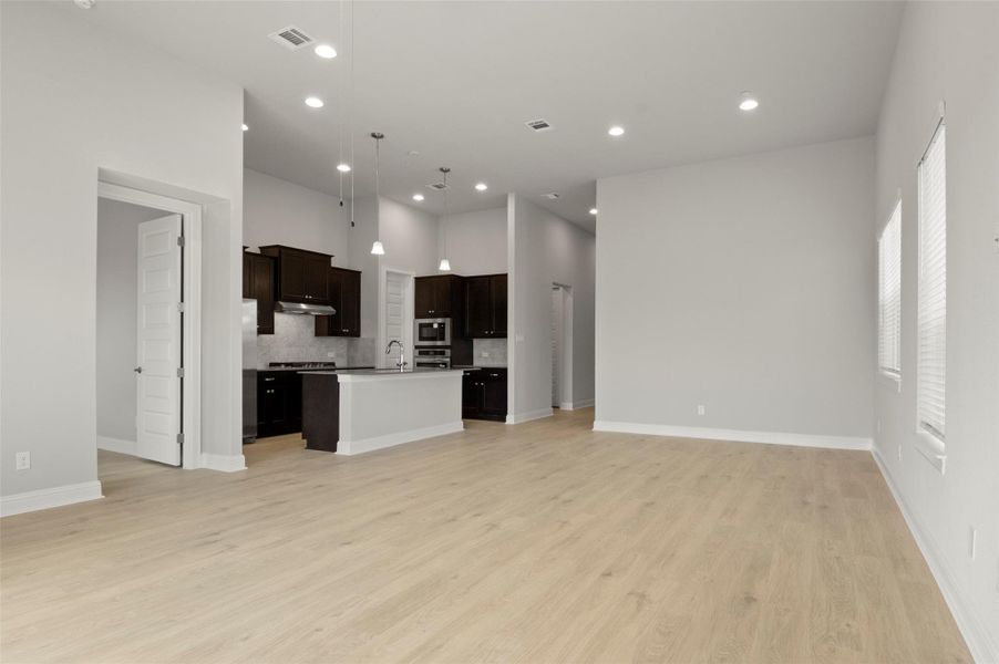Unfurnished living room featuring light wood-style floors and recessed lighting