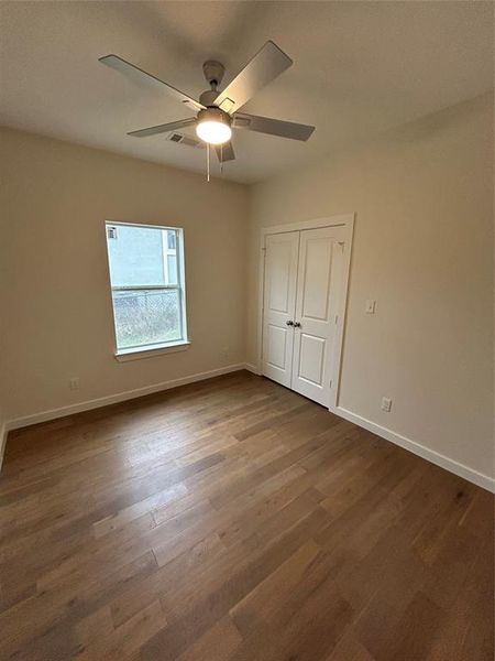 Bedroom with ceiling fan and dark hardwood / wood-style flooring