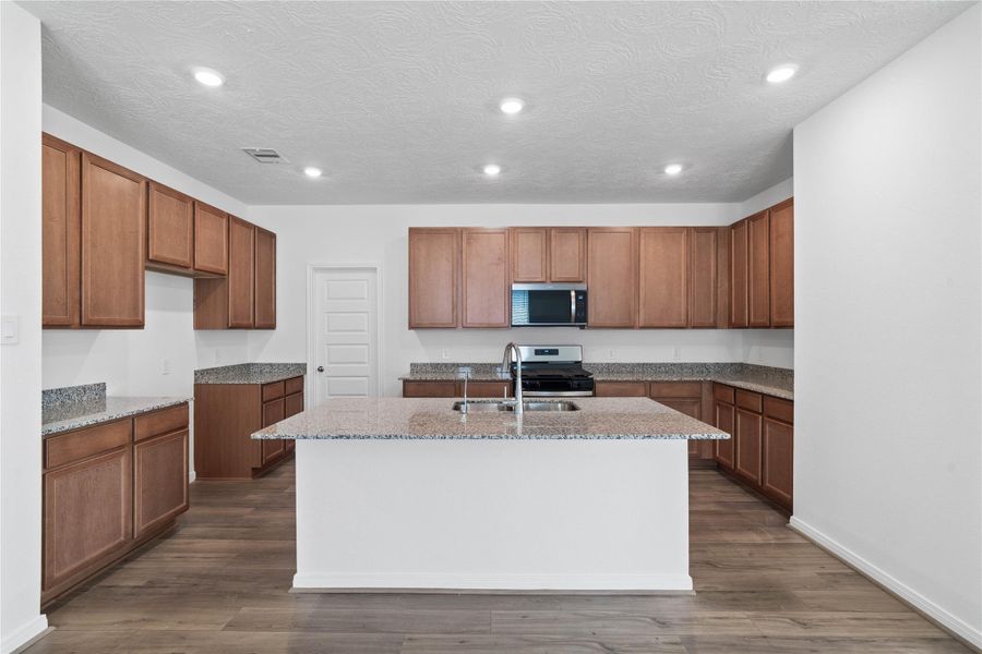 This spacious kitchen has it all—ample storage, generous counter space, and a layout that truly makes it the heart of the home.