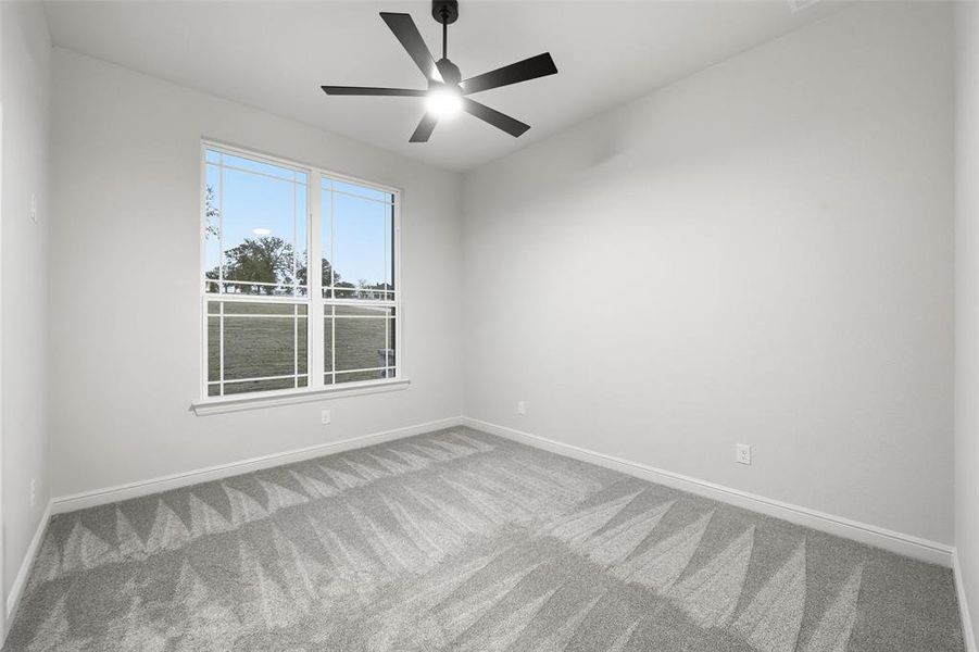 Unfurnished room featuring carpet and a ceiling fan Unfurnished room featuring carpet and a ceiling fan