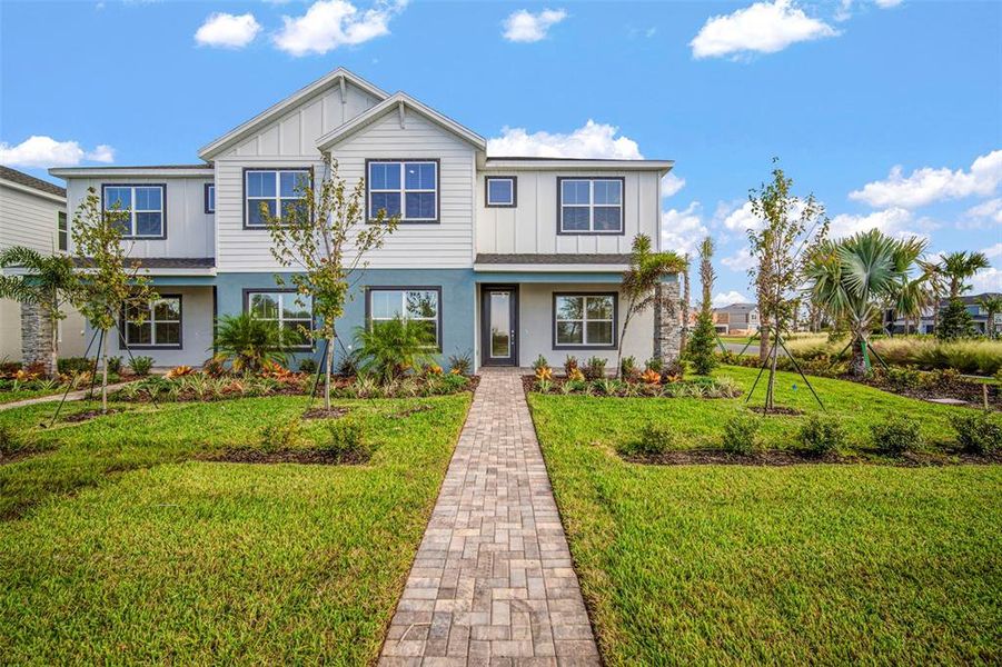 Front exterior of a new home in North River Ranch, Parrish, FL, highlighting curb appeal (Image 24).