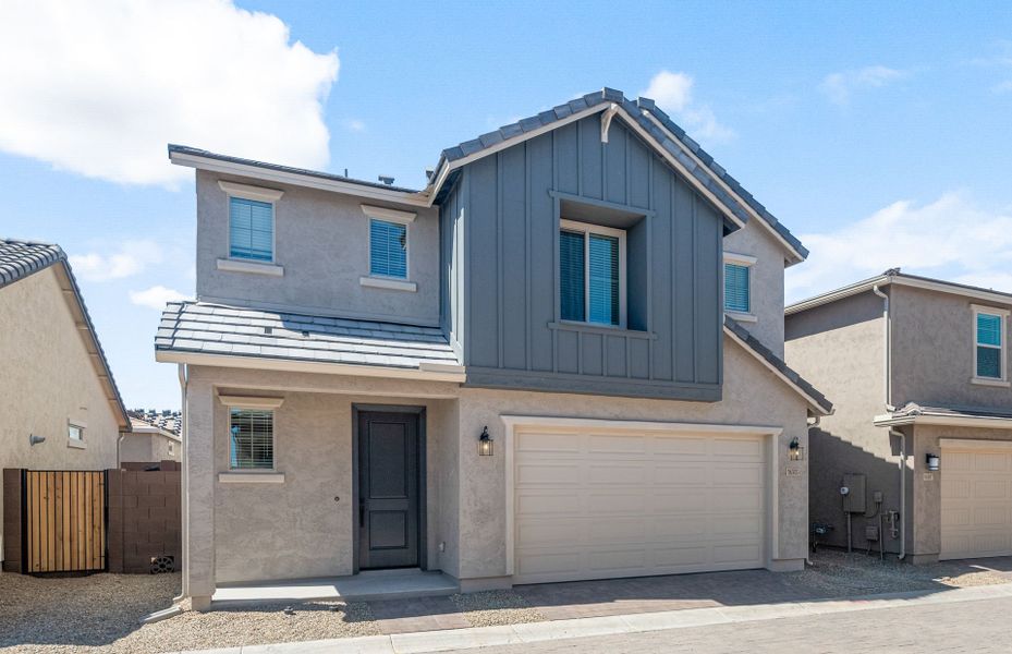 Front exterior of a new home in Asante- Atrium Series, Surprise, AZ, highlighting curb appeal (Image 2).