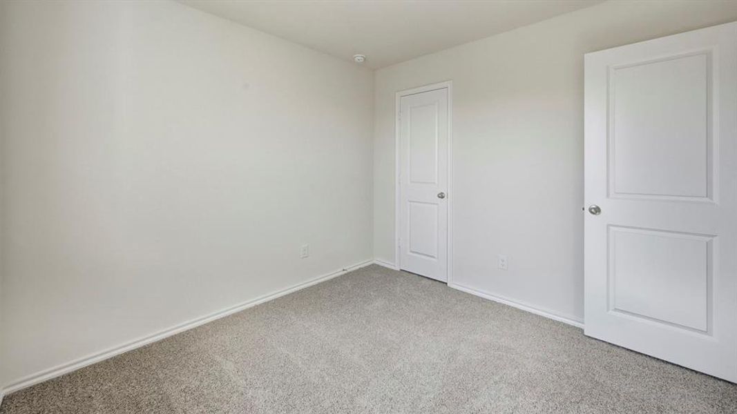 Unfurnished bedroom featuring carpet and baseboards