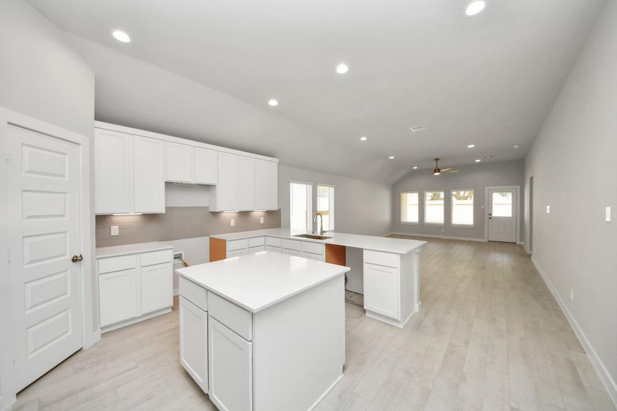 The extended counter area adds both practicality and style, making meal preparation a breeze. Every detail is thoughtfully designed to enhance the kitchen's functionality and aesthetic appeal. Sample photo of completed home with similar floor plan. Actual colors and selections may vary.