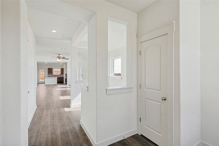 Corridor featuring dark wood-type flooring and recessed lighting