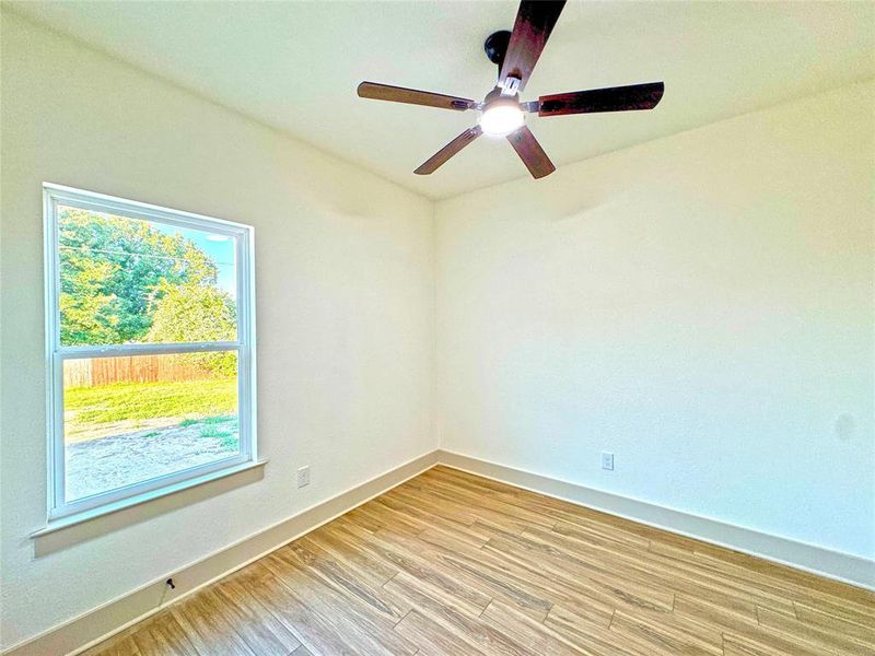 Unfurnished room featuring baseboards and wood finished floors