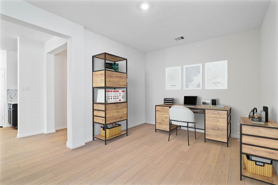 Quietly nestled in front of the home is the handsome home office or den. Featuring gorgeous flooring, custom paint and recessed lighting.