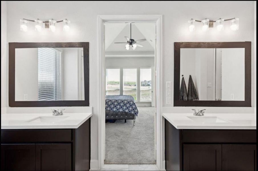 Ensuite bathroom with two vanities and ceiling fan
