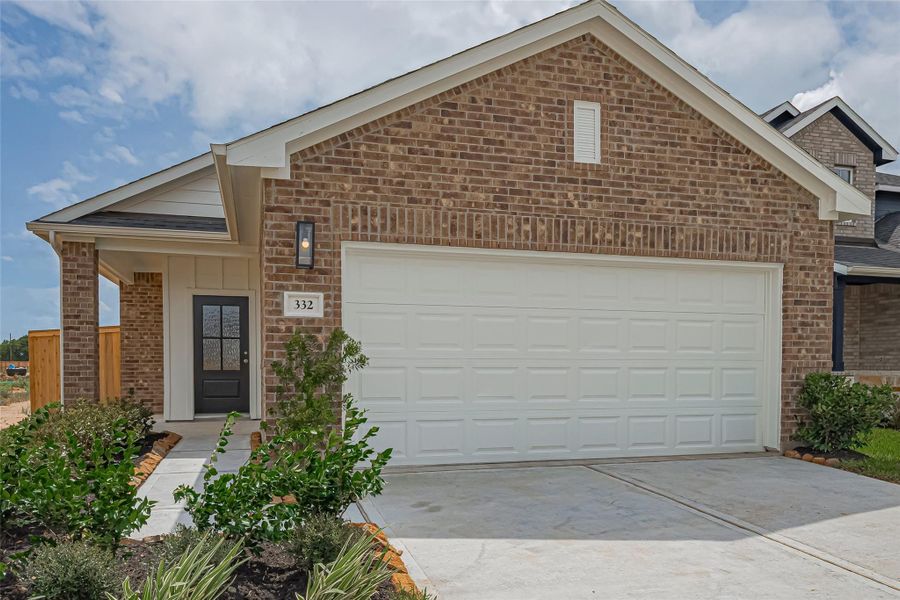 Front exterior of a new home in La Segarra, Brookshire, TX, highlighting curb appeal (Image 22).