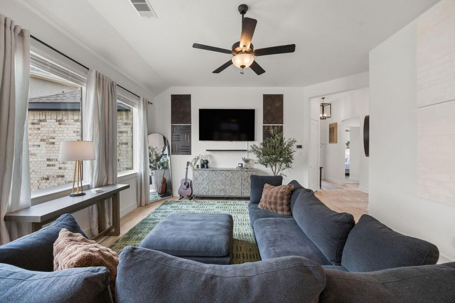 A well-proportioned living room offers flexible furniture placement and a designated media wall for comfortable everyday living.