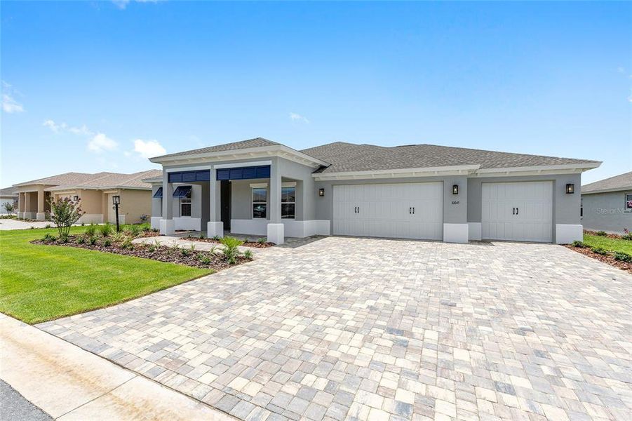 Front exterior of a new home in On Top of the World Communities, Ocala, FL, highlighting curb appeal (Image 10).
