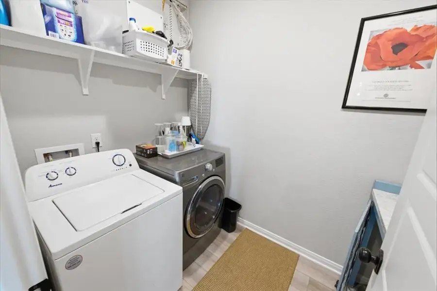 Laundry room featuring built-in pet kennel Laundry room featuring built-in pet kennel