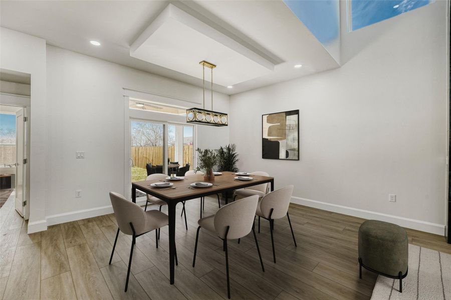 The expansive open concept dining area offers ample room for a large dining table under an exquisite designer chandelier. (virtually staged photo)