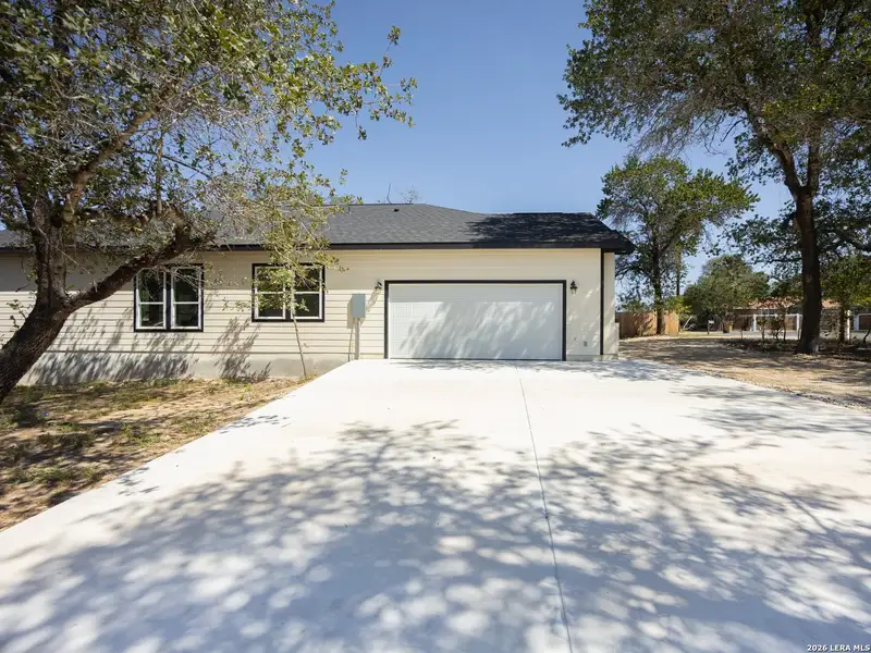 Front exterior of a new home in , Elmendorf, TX, highlighting curb appeal (Image 28).