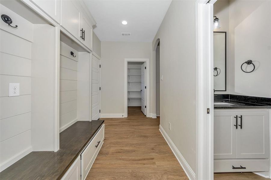 Mudroom featuring sink and light wood-type flooring