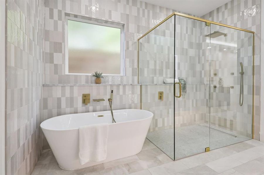 Full bathroom featuring tile walls, a freestanding tub, and a stall shower