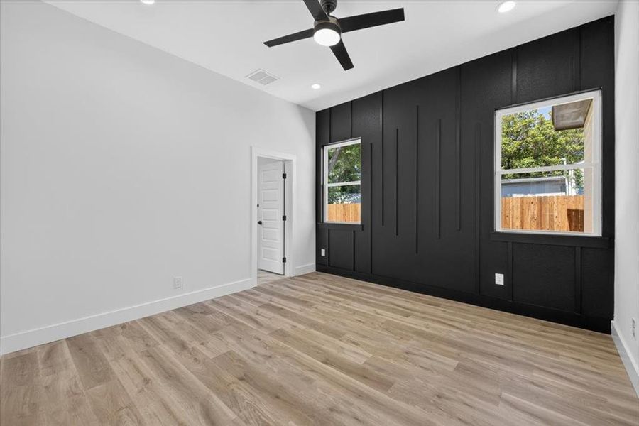 Accent wall with vertical paneling and two windows Accent wall with vertical paneling and two windows