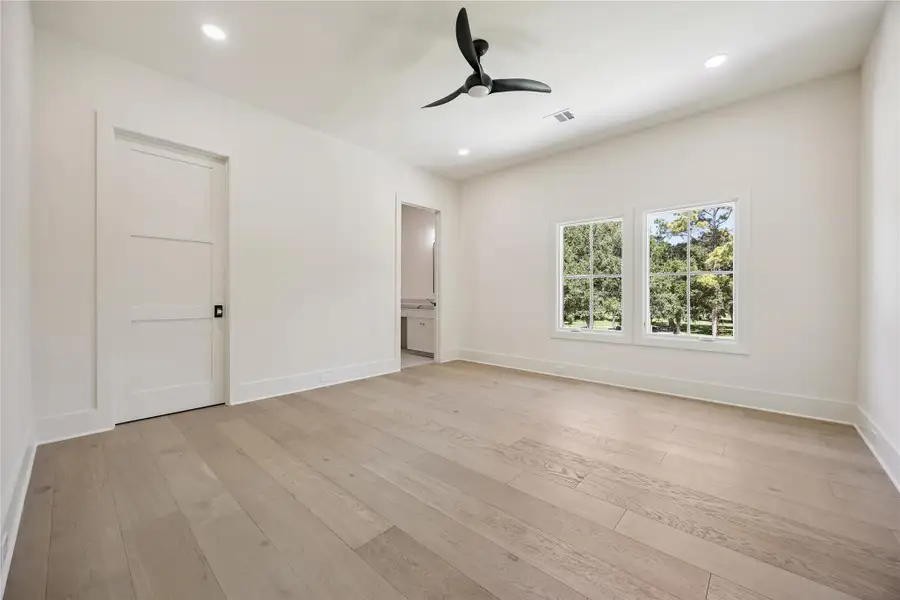 BEDROOM II: Comfortable secondary bedroom is thoughtfully designed with hardwood floors, a walk-in closet, and an abundant natural light, making it ideal for family or guests.
