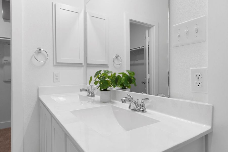 Dual-sink vanity with modern fixtures and extra counter space, perfectly designed for busy mornings. Medicine cabinet for more storage. Dual-sink vanity with modern fixtures and extra counter space, perfectly designed for busy mornings. Medicine cabinet for more storage.