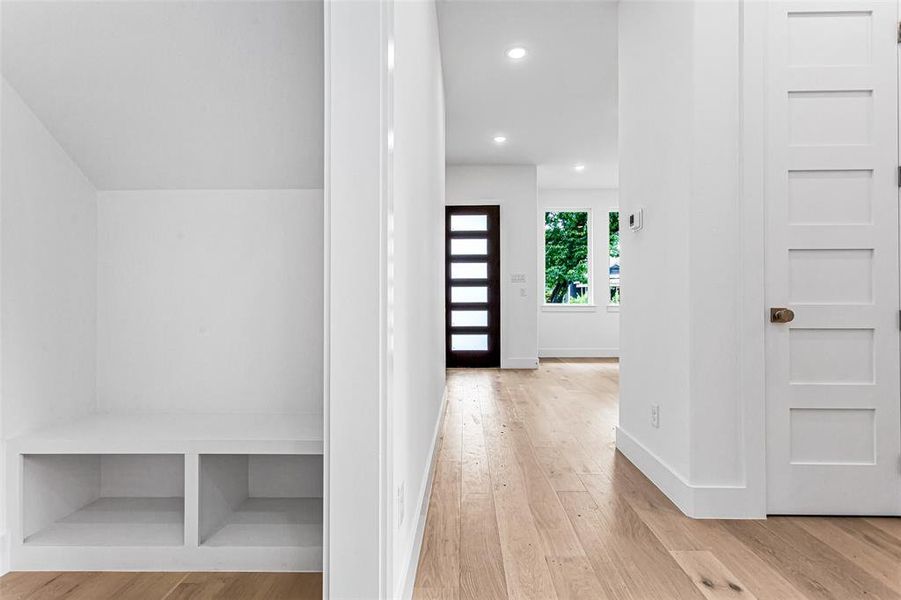 Hallway with wood finished floors, baseboards, and recessed lighting