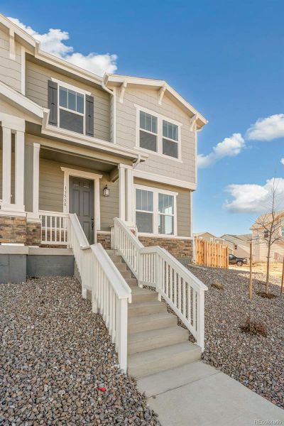 Exterior details and patio area of a home in Turnberry, Commerce City (Image 25).