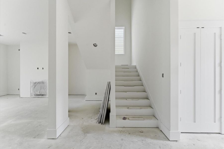 Living area and stairs leading to the second floor.