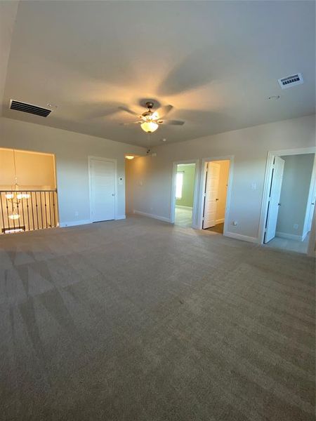 Unfurnished bedroom with carpet flooring and ceiling fan Unfurnished bedroom with carpet flooring and ceiling fan