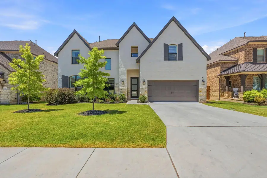 Front exterior of a new home in Parmer Ranch, Georgetown, TX, highlighting curb appeal (Image 1). Front exterior of a new home in Parmer Ranch, Georgetown, TX, highlighting curb appeal (Image 1).