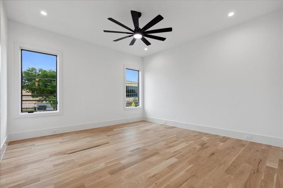 Empty room featuring light hardwood / wood-style flooring and ceiling fan