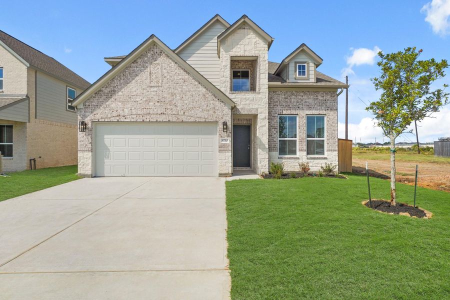 Front exterior of a new home in Huntington Place, Rosharon, TX, highlighting curb appeal (Image 1). Front exterior of a new home in Huntington Place, Rosharon, TX, highlighting curb appeal (Image 1).
