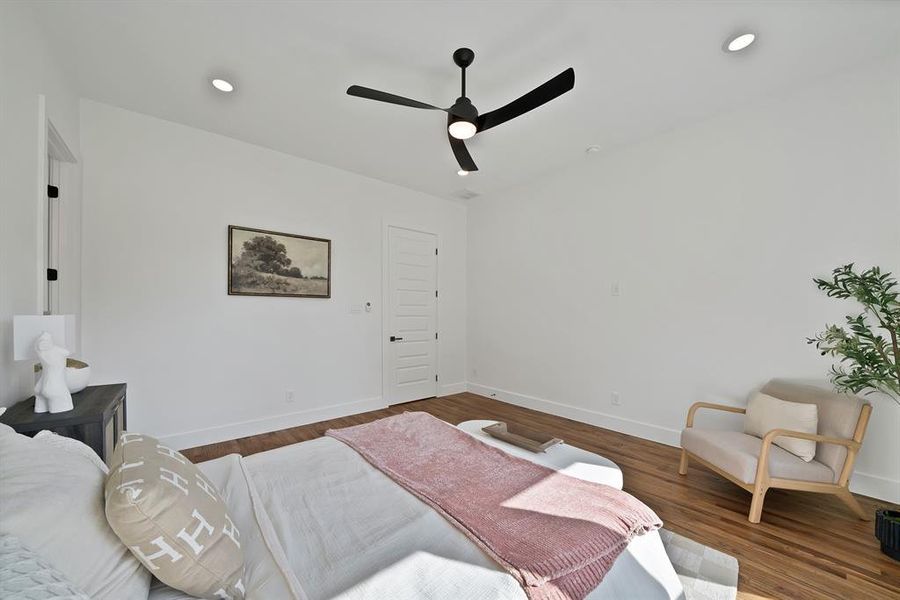 Bedroom with wood finished floors, a ceiling fan, and recessed lighting Bedroom with wood finished floors, a ceiling fan, and recessed lighting