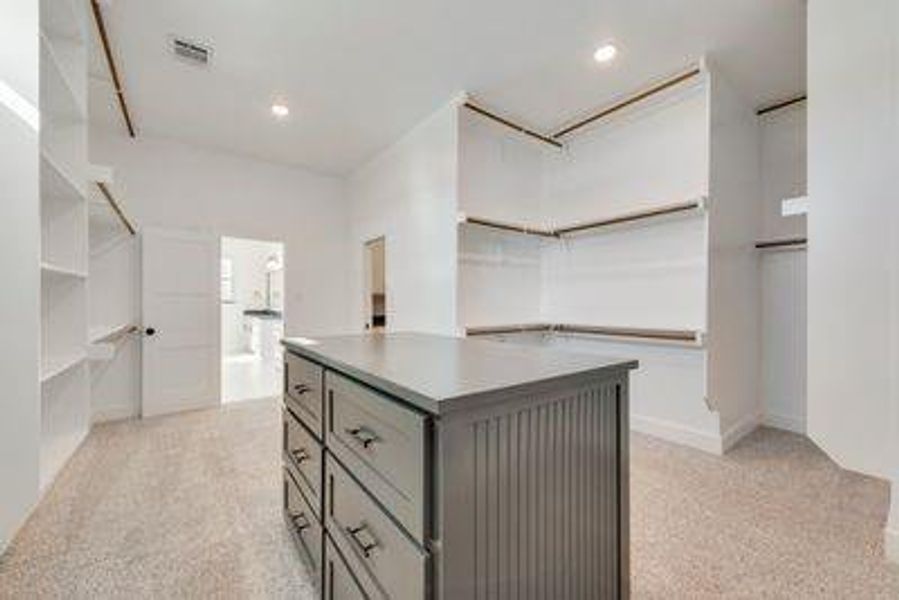 Walk in closet featuring light colored carpet