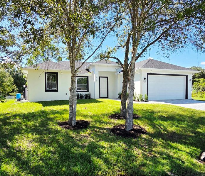 Front exterior of a new home in , Okeechobee, FL, highlighting curb appeal (Image 19).