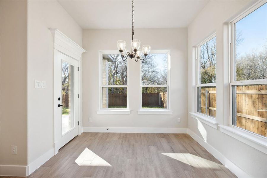 Unfurnished sunroom with a notable chandelier