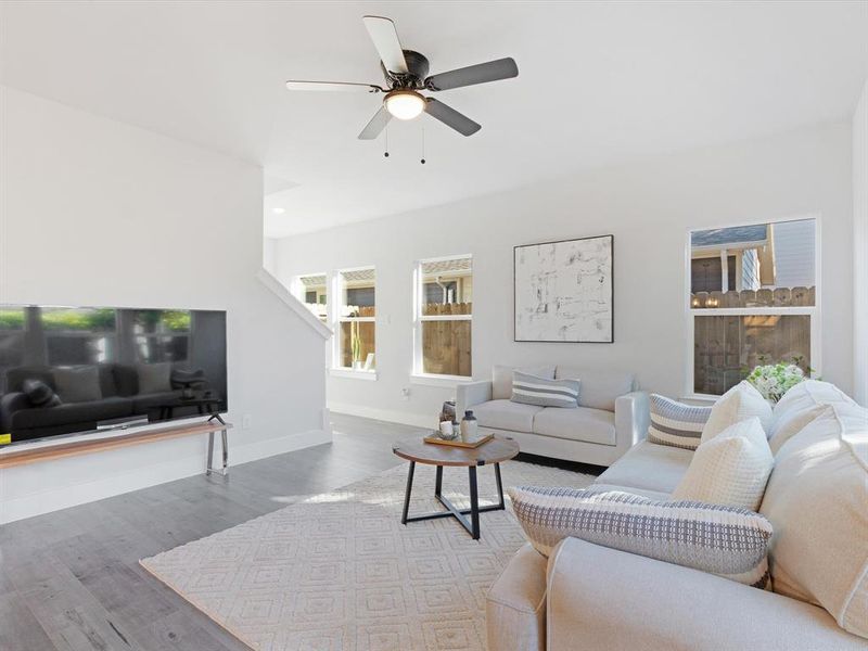 Living room with hardwood / wood-style floors and ceiling fan