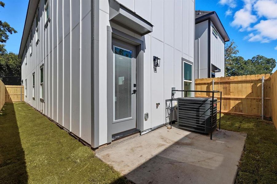 View of exterior entry featuring board and batten siding and a patio View of exterior entry featuring board and batten siding and a patio