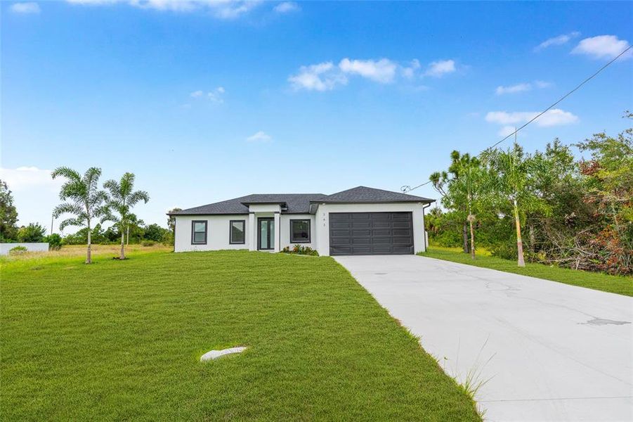 Front exterior of a new home in , Lehigh Acres, FL, highlighting curb appeal (Image 22). Front exterior of a new home in , Lehigh Acres, FL, highlighting curb appeal (Image 22).