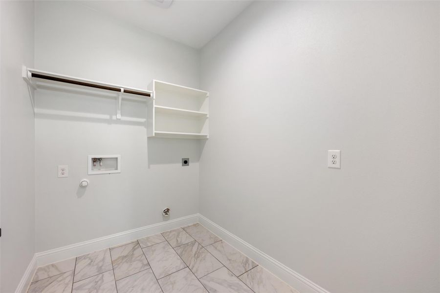 Laundry area featuring hookup for an electric dryer, washer hookup, light marble finish flooring, and hookup for a gas dryer