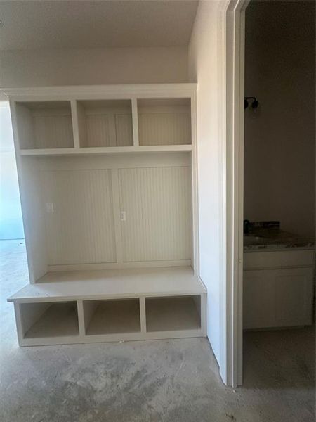 Mud bench and guest half bath off the garage entrance Mud bench and guest half bath off the garage entrance